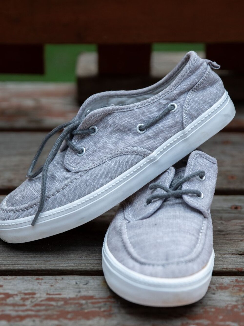 Light gray canvas boat shoes with white rubber soles size 5.